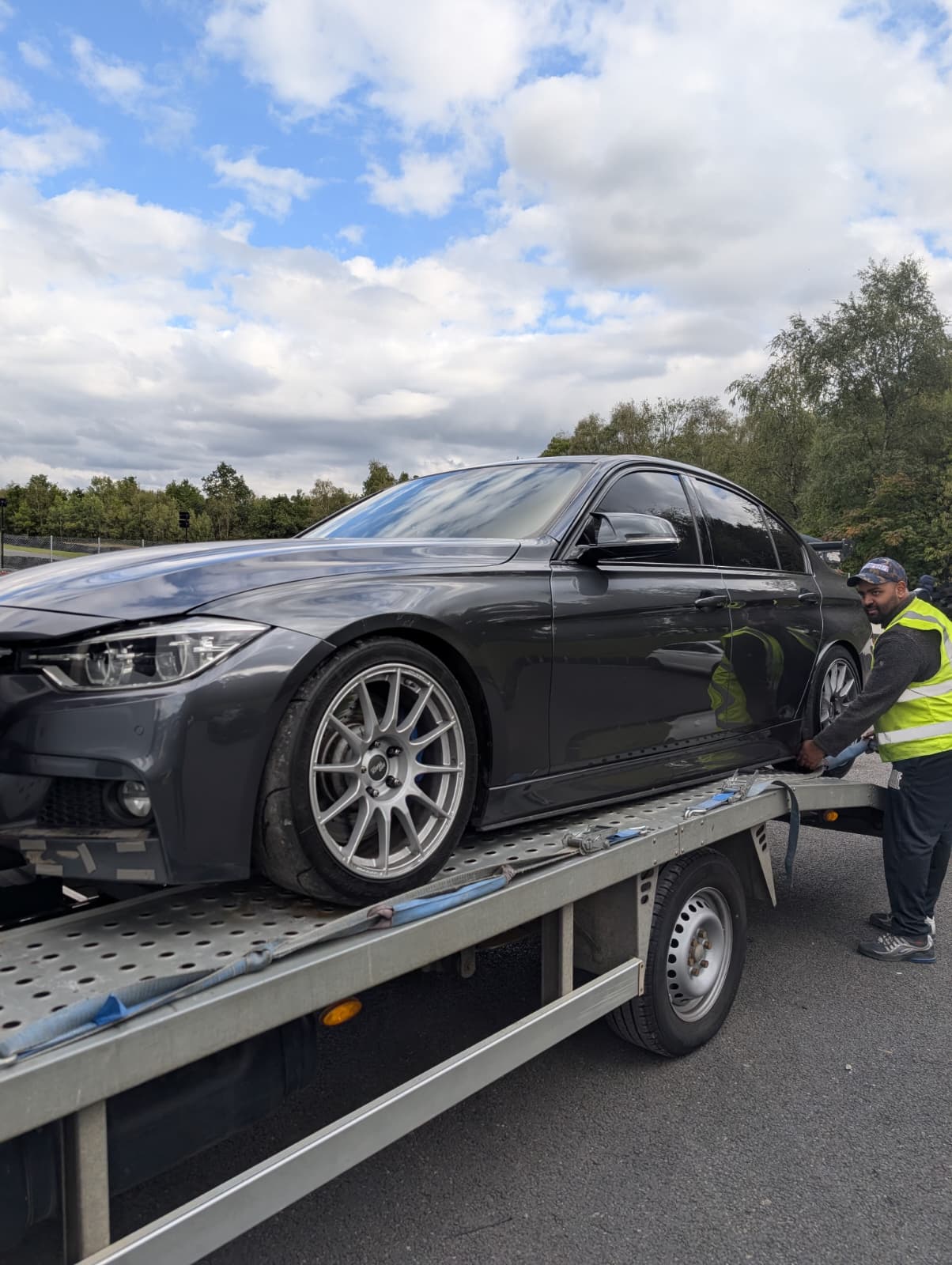 Professional recovery technician securing BMW